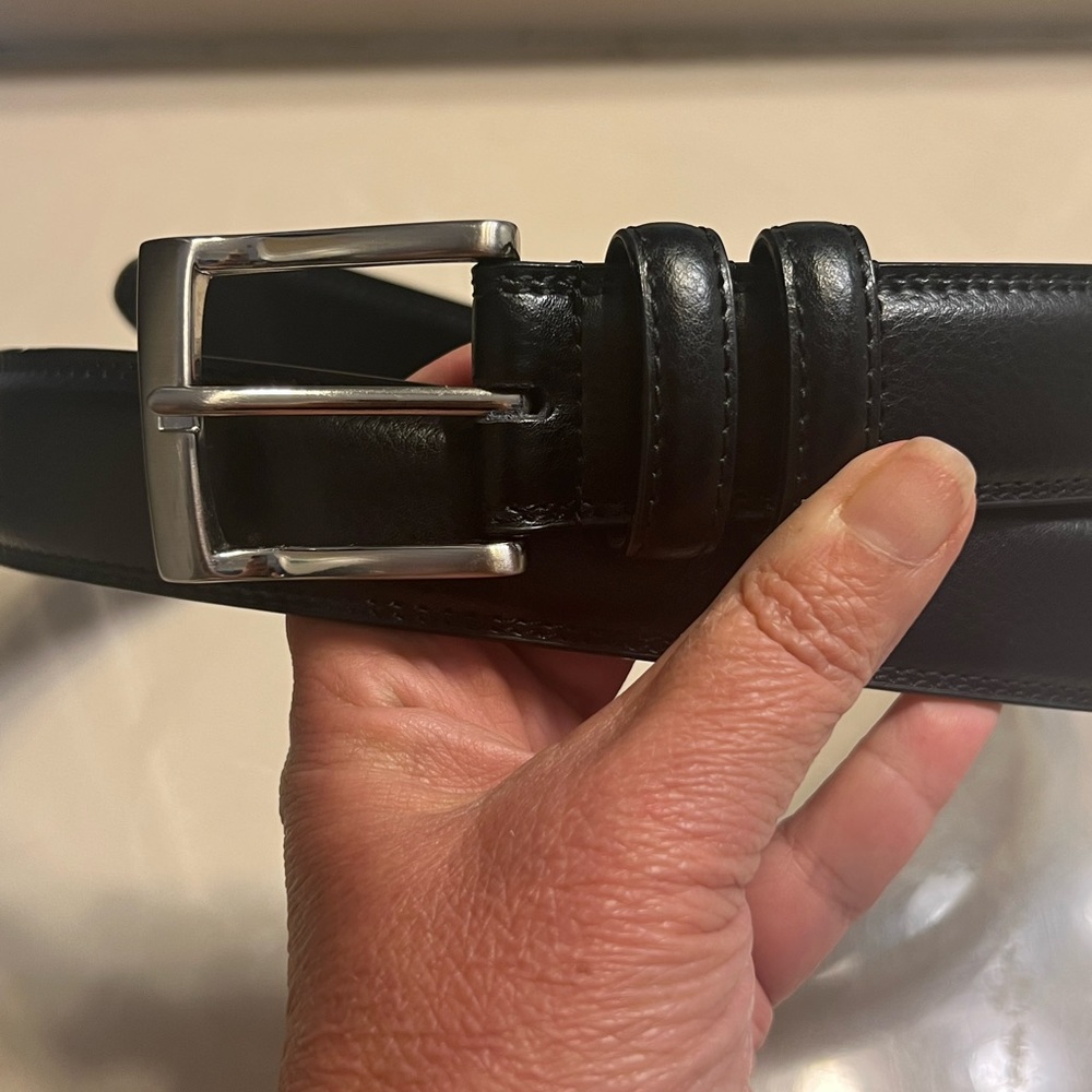 Florsheim black leather belt with silver tone buckle. Size 40